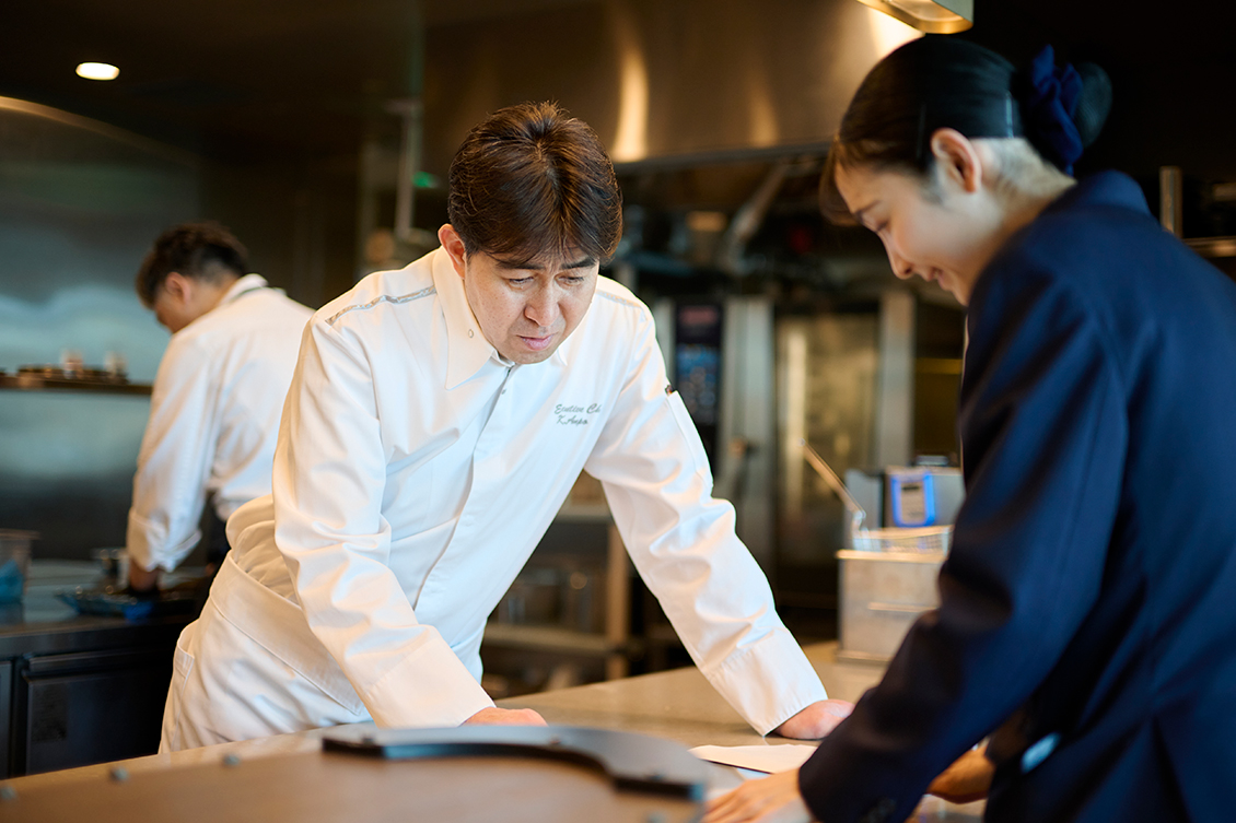 アソシエイツと打ち合わせをする料理長安保